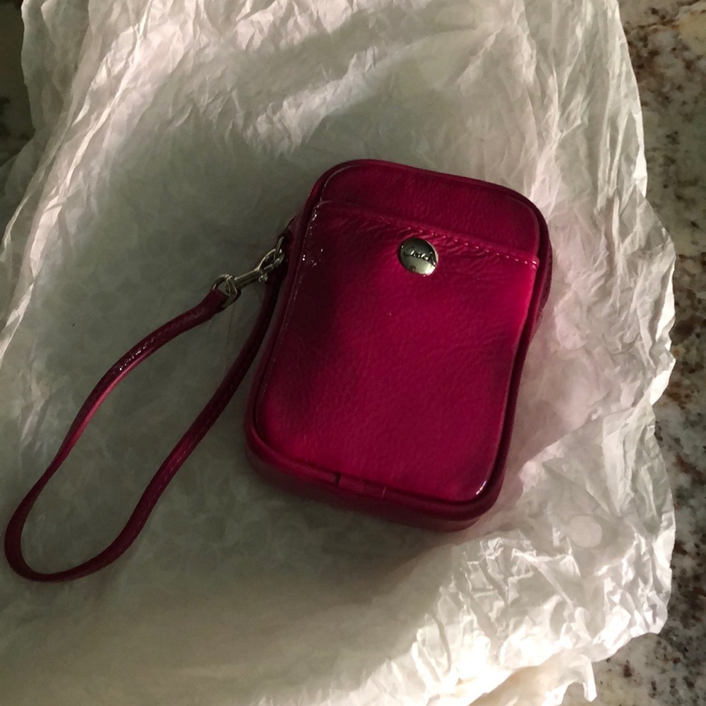 Coach, Hot Pink wristlet
4x5 inches, never usef